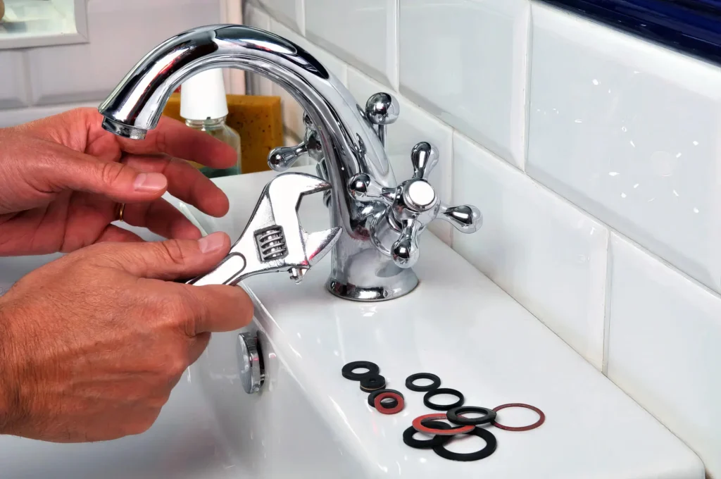 Plumber performing maintenance on a bathroom faucet in St. Petersburg