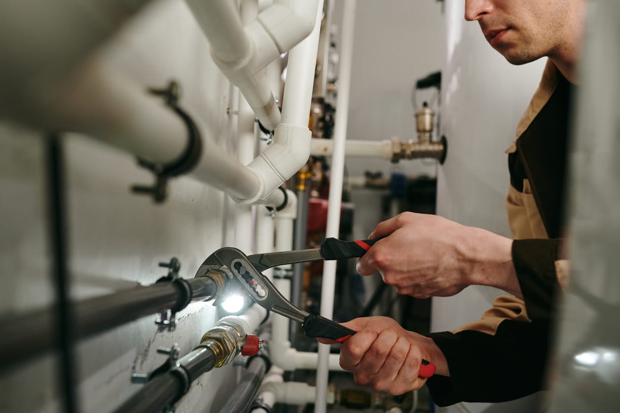 Plumbers maintaining commercial plumbing pipes in St. Petersburg